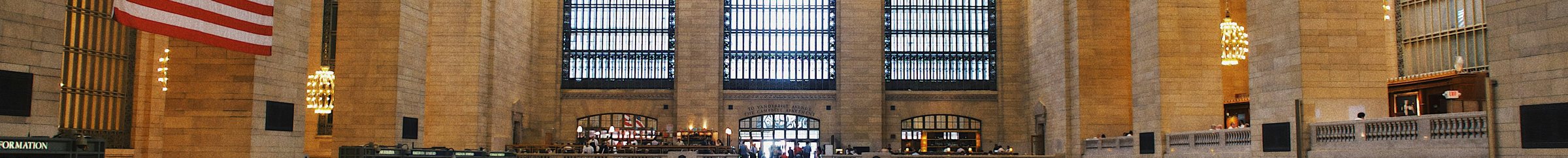 The main concourse of Grand Central Terminal, New York — limestone piers, arched windows and chandeliers.