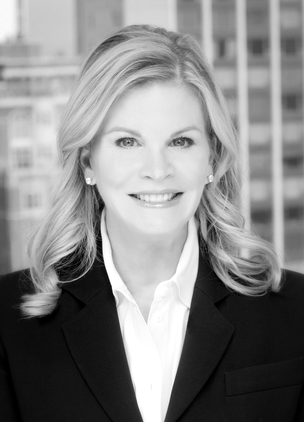 Sandra Reese, black-and-white portrait against a city building backdrop.